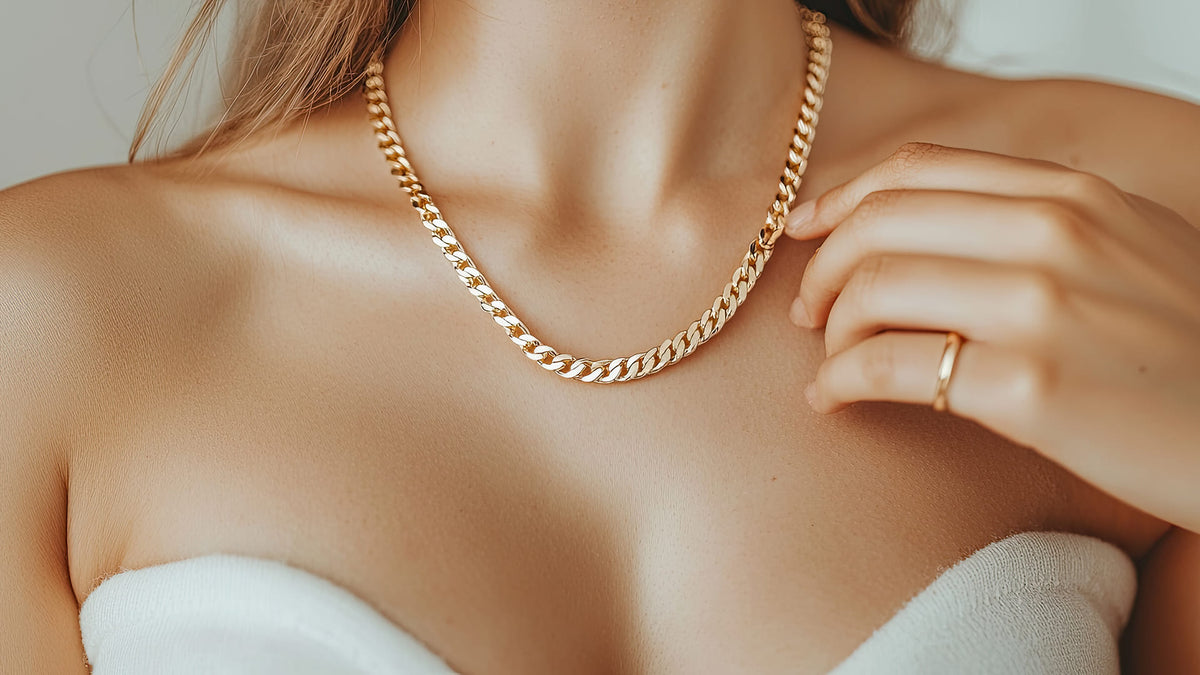 Gold chain necklace on a person