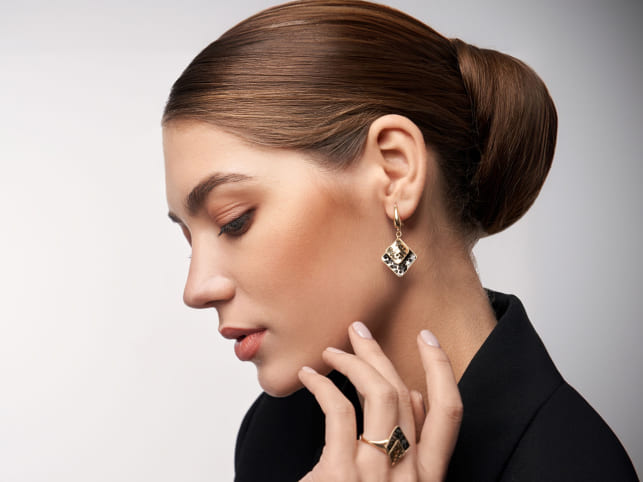 Woman wearing a diamond earring and ring